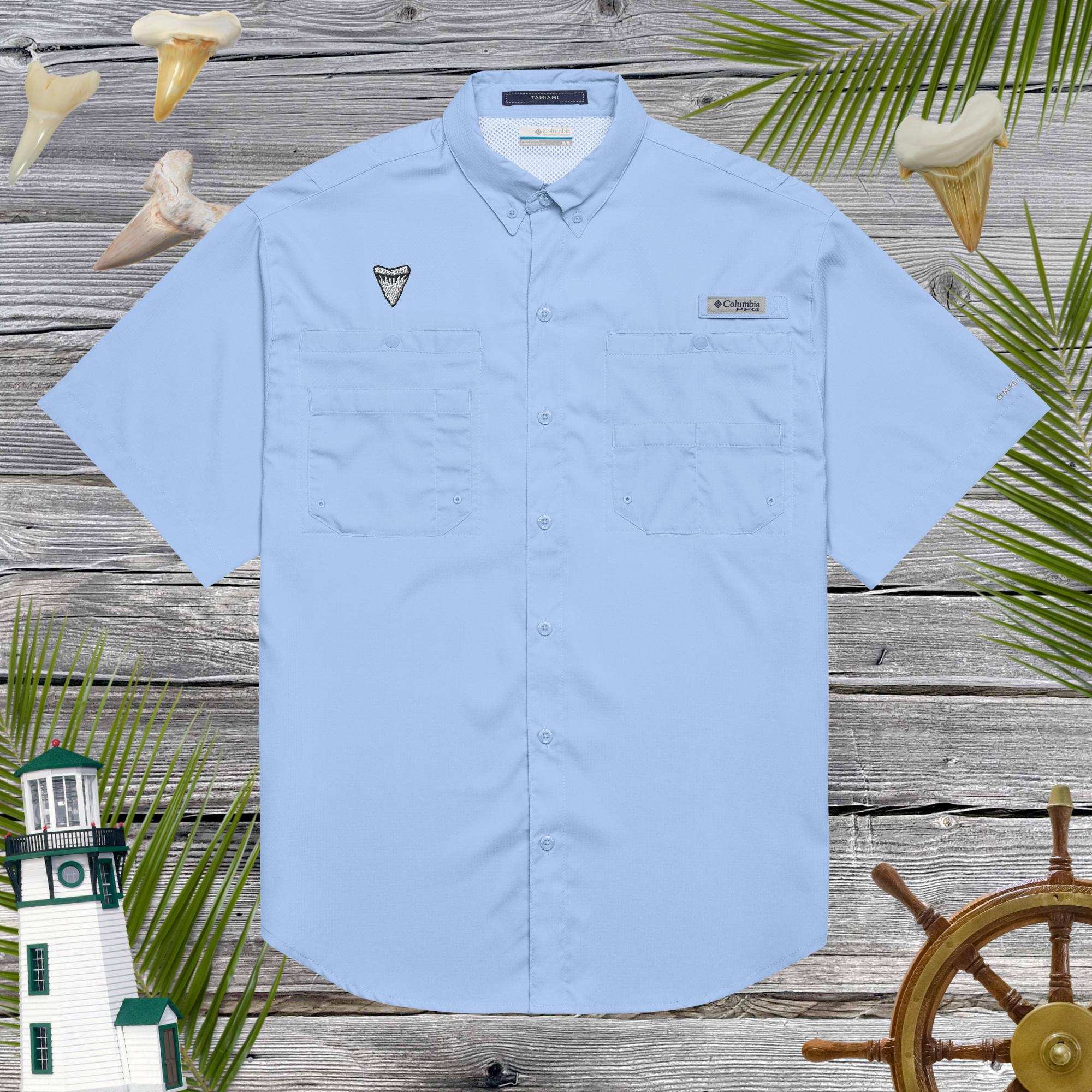 Light blue short-sleeve fishermans' shirt with embroidered shark tooth on a wooden background with nautical elements.