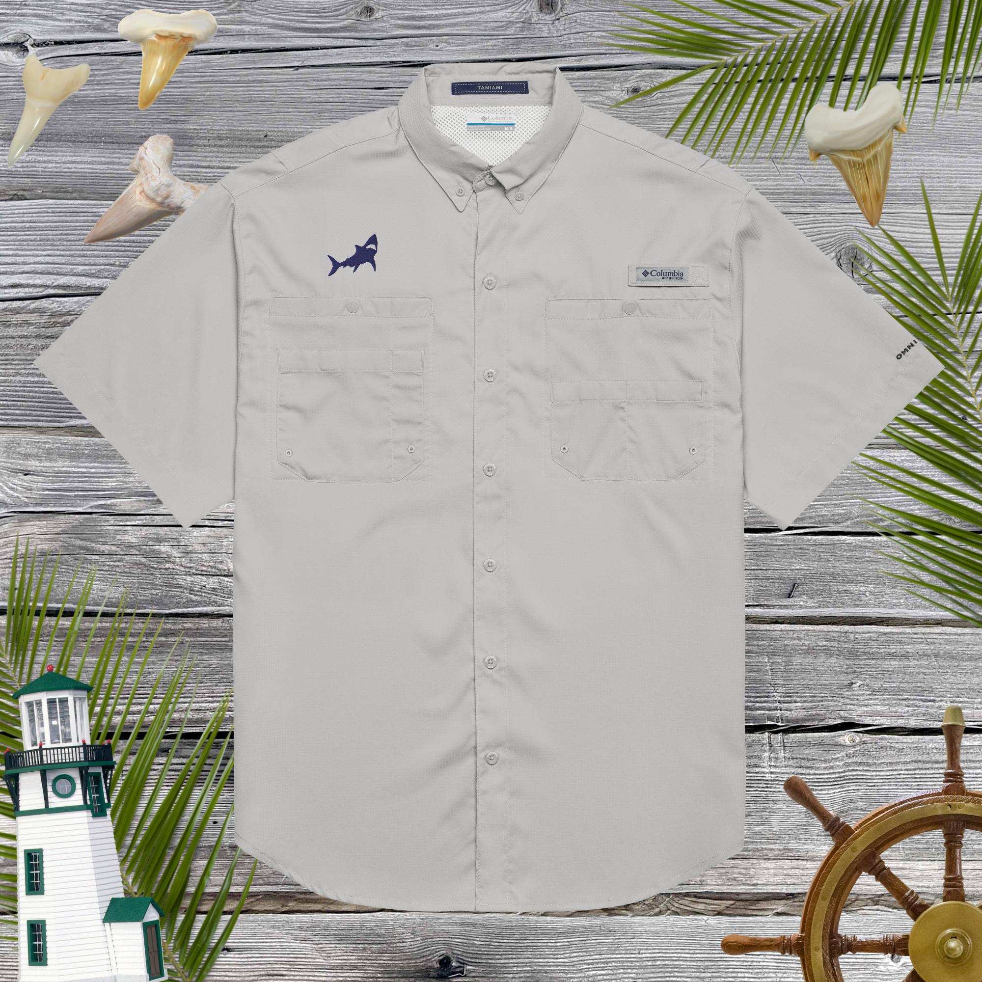 Light gray short-sleeve shirt with embroidered shark design on a wooden background with decorative elements.