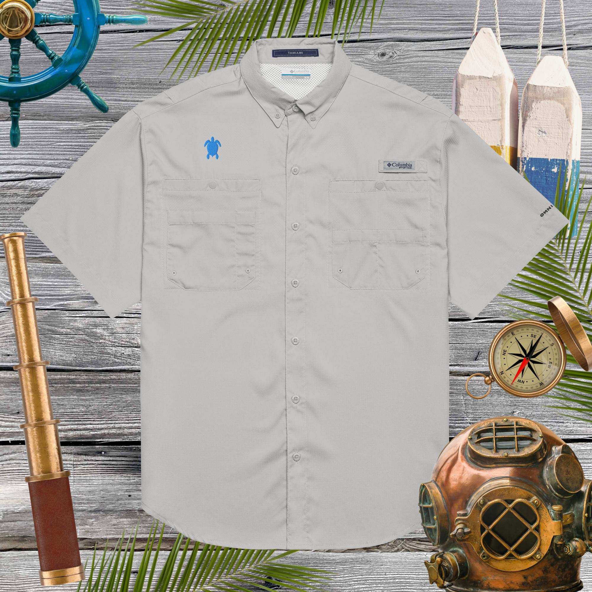 Light gray shirt with embroidered sea turtle on a wooden background with nautical-themed decor
