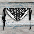 Black and white paisley patterned bikini bottom with straps on a white background