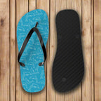 Blue flip-flop with dolphin pattern and black insole on a white background