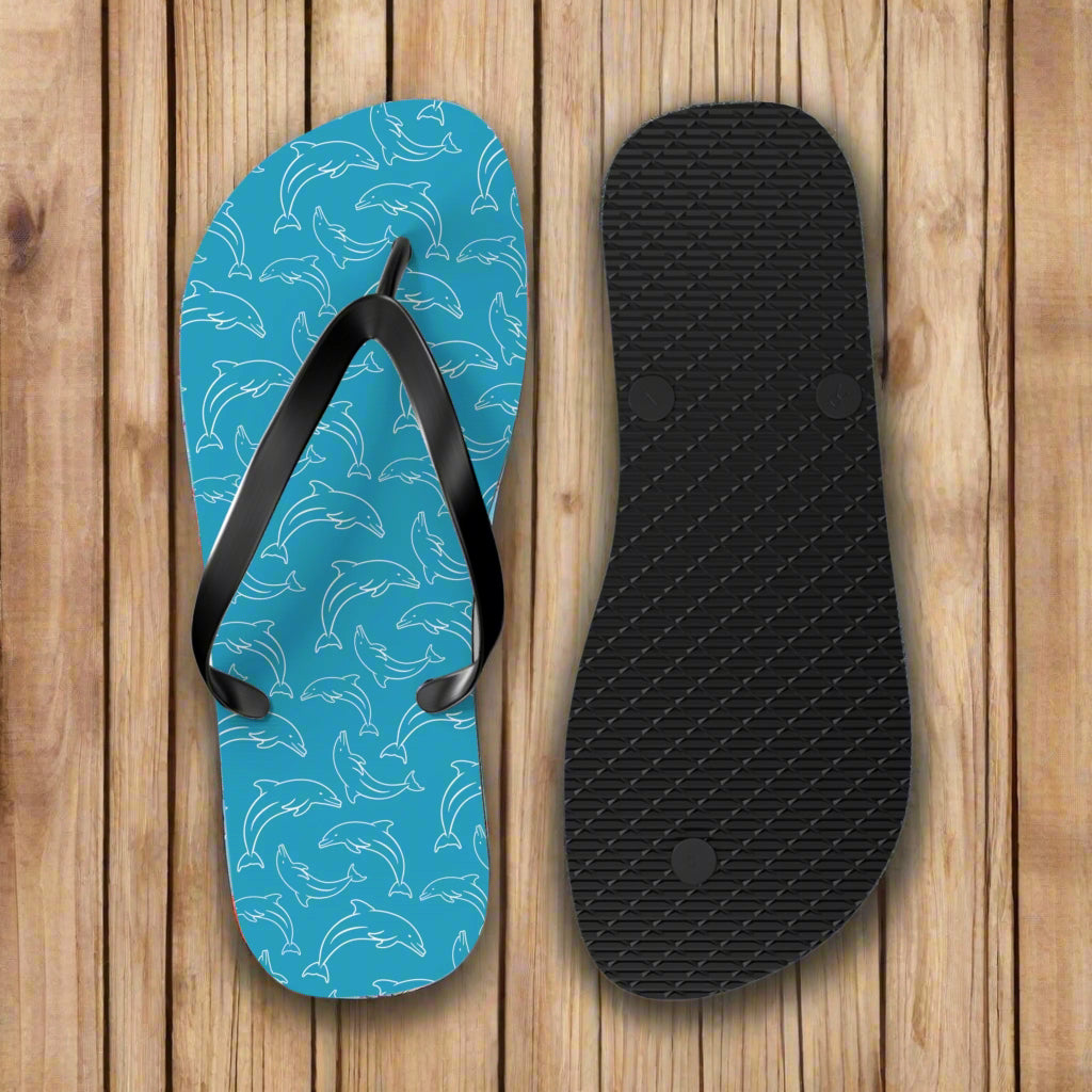 Blue flip-flop with dolphin pattern and black insole on a white background