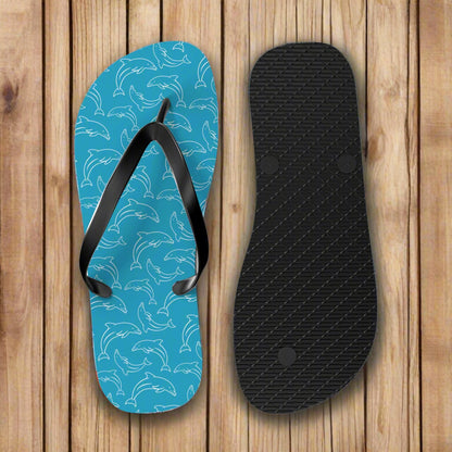 Blue flip-flop with dolphin pattern and black insole on a white background