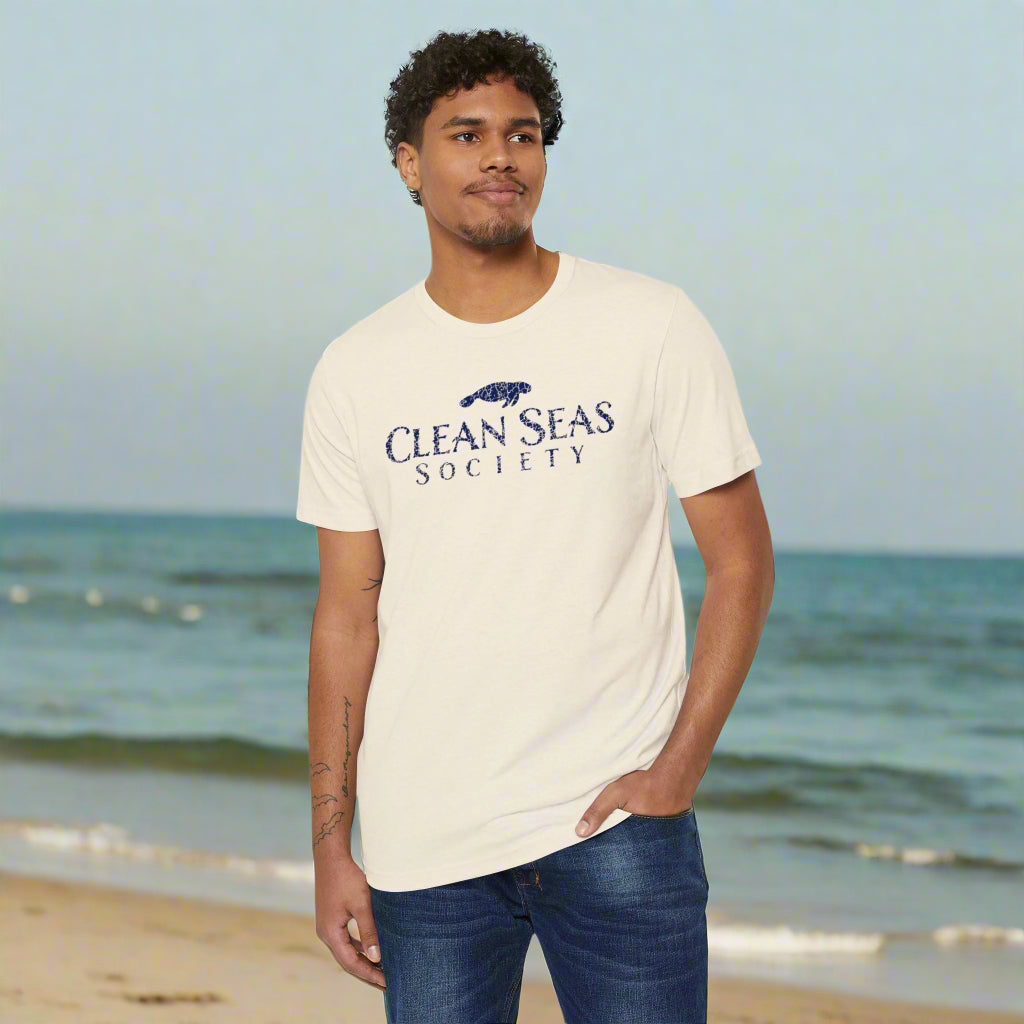 Man wearing an eco-friendly 'Clean Seas Society' t-shirt hanging out at a beach cleaning party