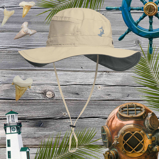 Beige booney hat on a wooden background with nautical decorations.
