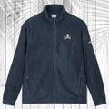 A dark navy blue fleece zip-up jacket with a small white skull and crossbones embroidered on the left chest, displayed flat against a white wood plank background with a palm leaf overlay.
