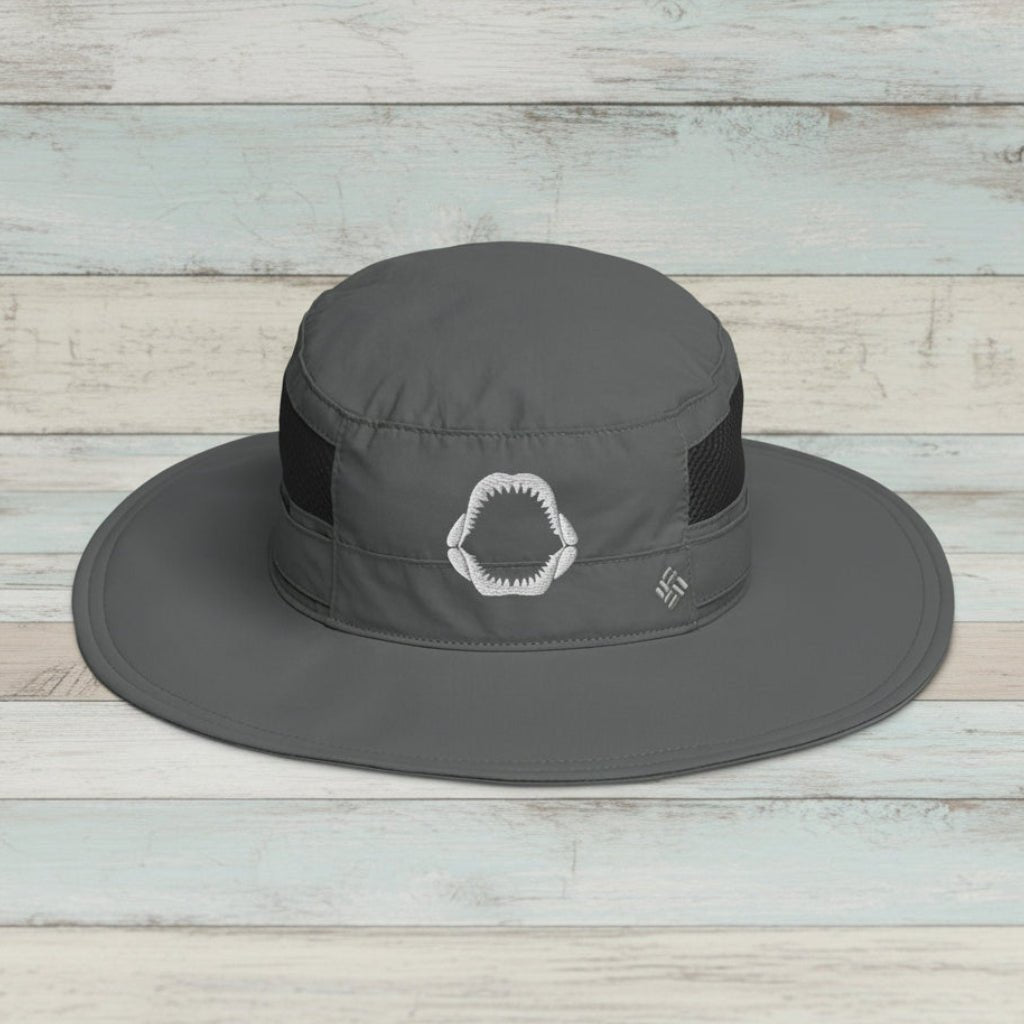 Gray wide-brimmed fishing hat with black band on a rustic wood background