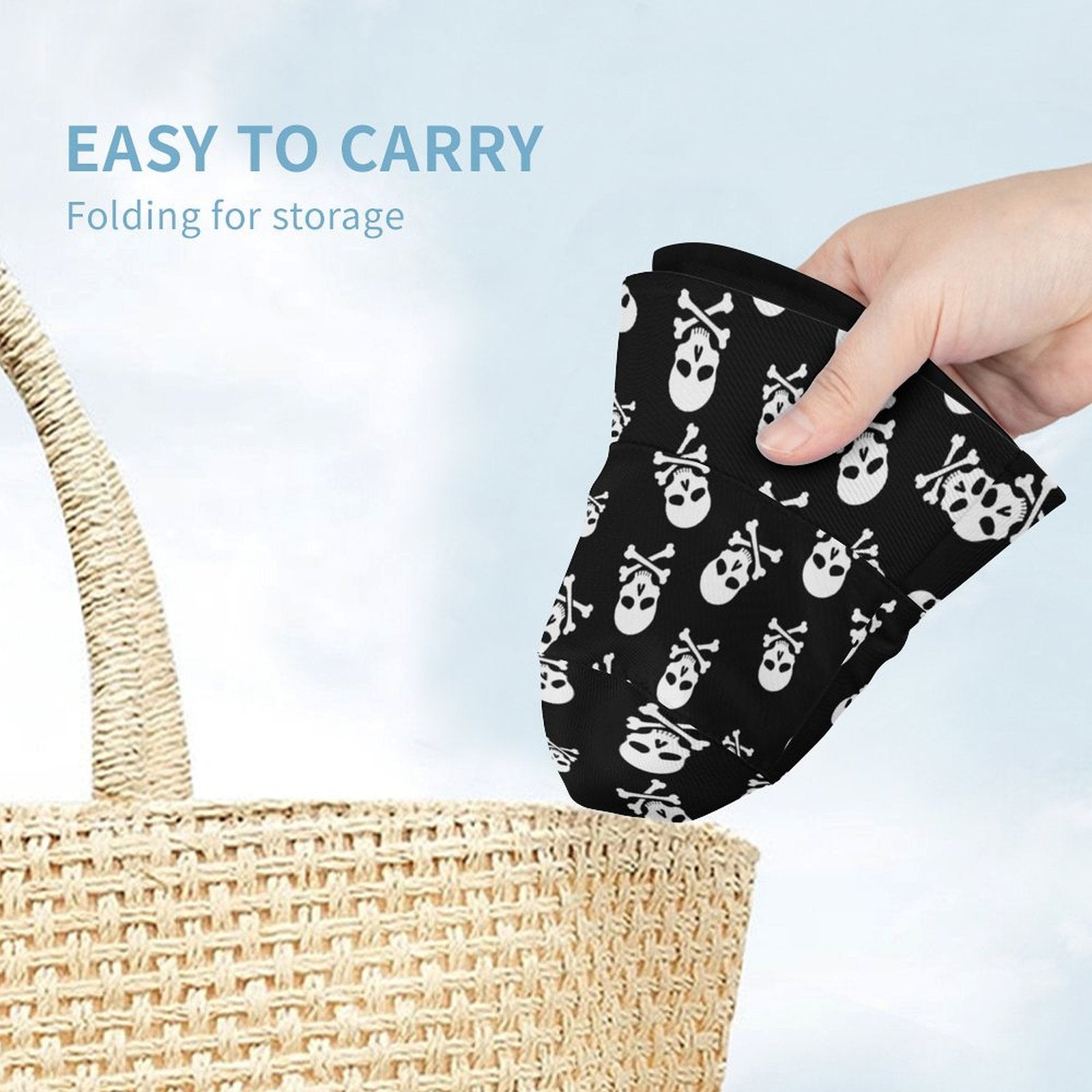 Hand holding a black bucket hat with white skull patterns above a woven basket, with text 'Easy to carry' and 'Folding for storage