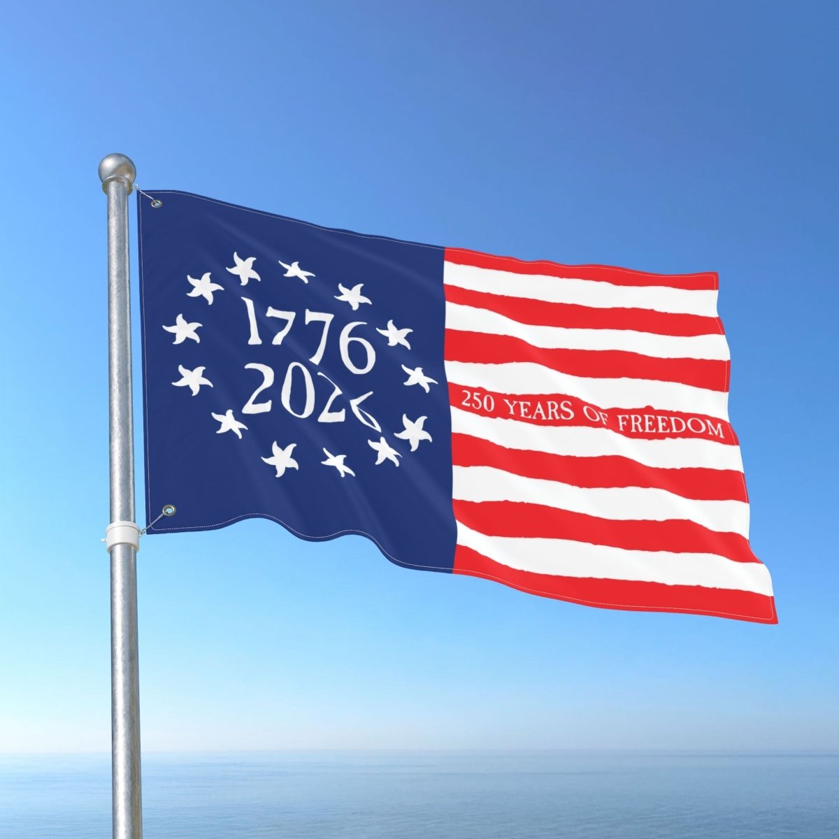 Flag with '1776 2026' and '250 Years of Freedom' text against a blue sky.