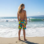 Teen Surfer wearing colorful geometric patterned shorts on a Hawaiian beach
