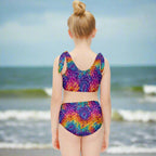 Model wearing a colorful tie-dye swimsuit watching the waves come in at Cocoa Beach