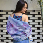 Swimsuit model wrapped in a beach towel with pink dolphins jumping