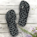 Flip-flops with black pattern on gray nautical wood background