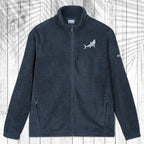 A dark gray fleece zip-up jacket with a stand collar, shown flat against a white wood plank background with a palm leaf pattern overlay. The jacket features a Great White Shark embroidered on the left chest and a small white logo on the right sleeve.