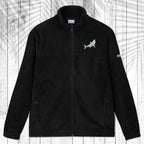 A dark gray fleece zip-up jacket with a stand collar, shown flat against a white wood plank background with a palm leaf pattern overlay. The jacket features a small white circular logo on the left chest and a small white logo on the right sleeve.