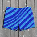 Blue striped swim trunks on rustic nautical wood surface