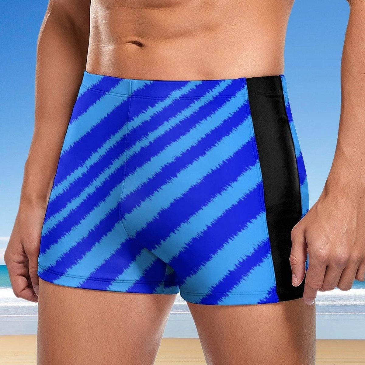 Blue striped swim shorts with black side panel on a beach background
