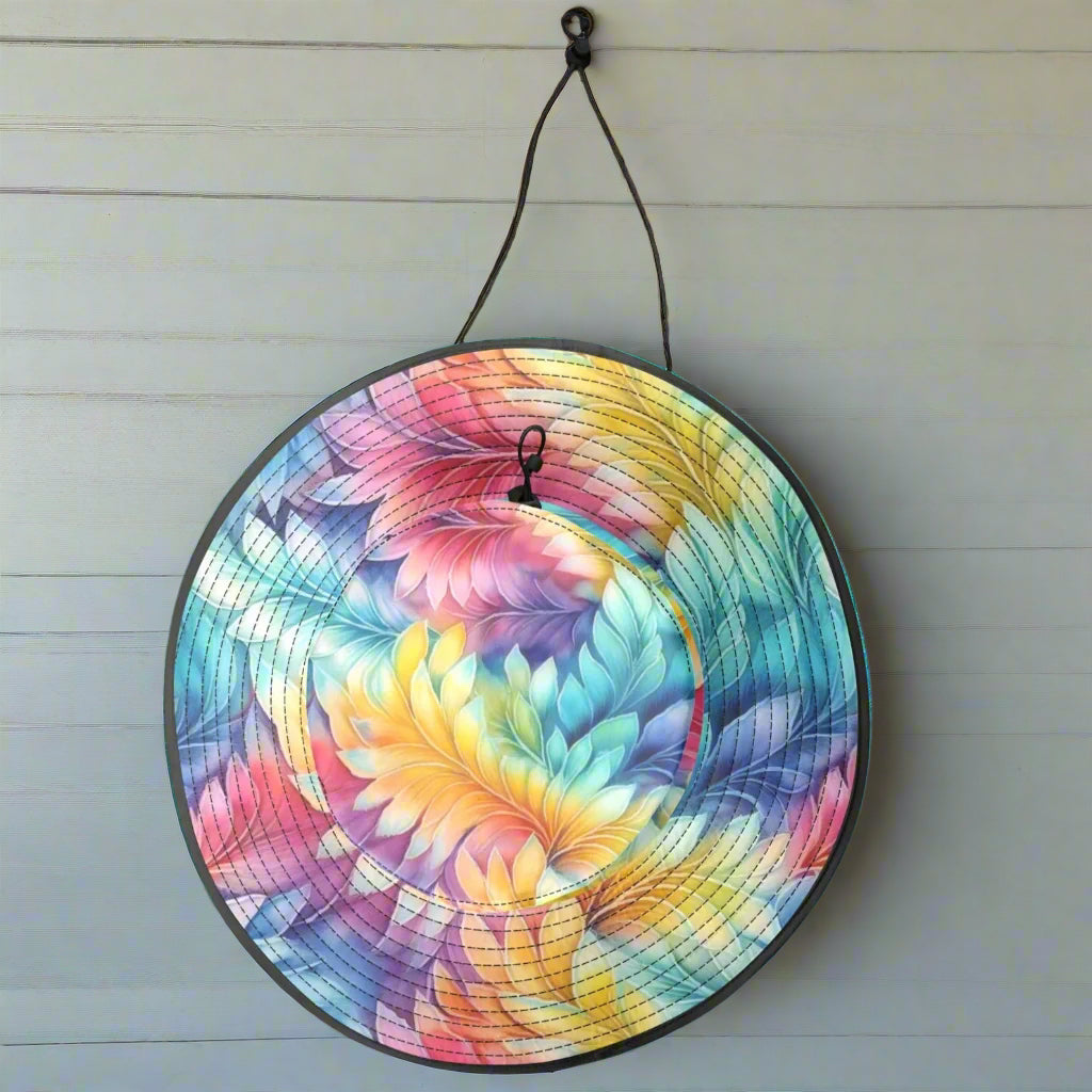 Colorful wide brim beach hat hanging by its chinstrap on a rustic wood wall of a tiki hut
