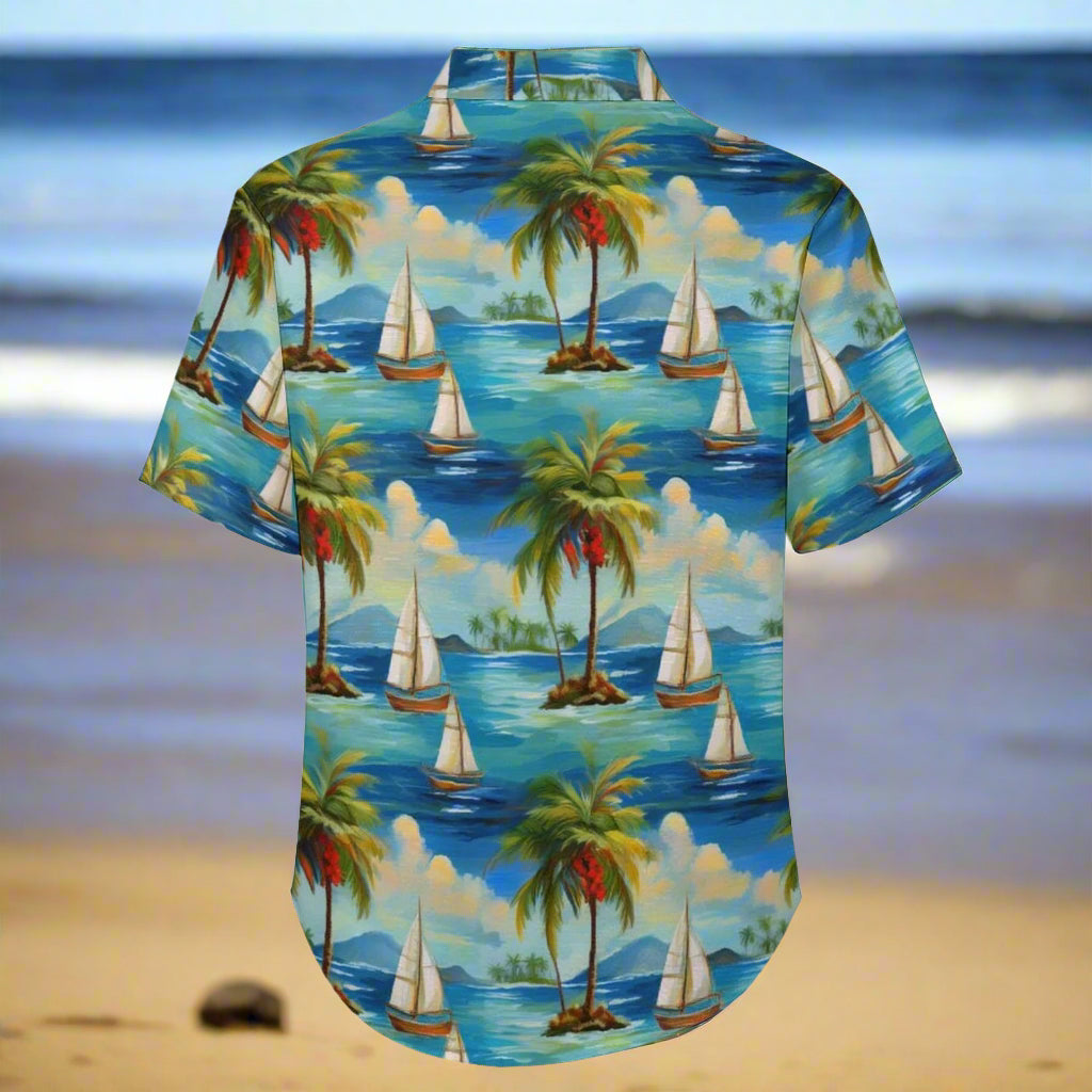 Hawaiian shirt with tropical island design featuring palm trees and sailboats on a blue background.