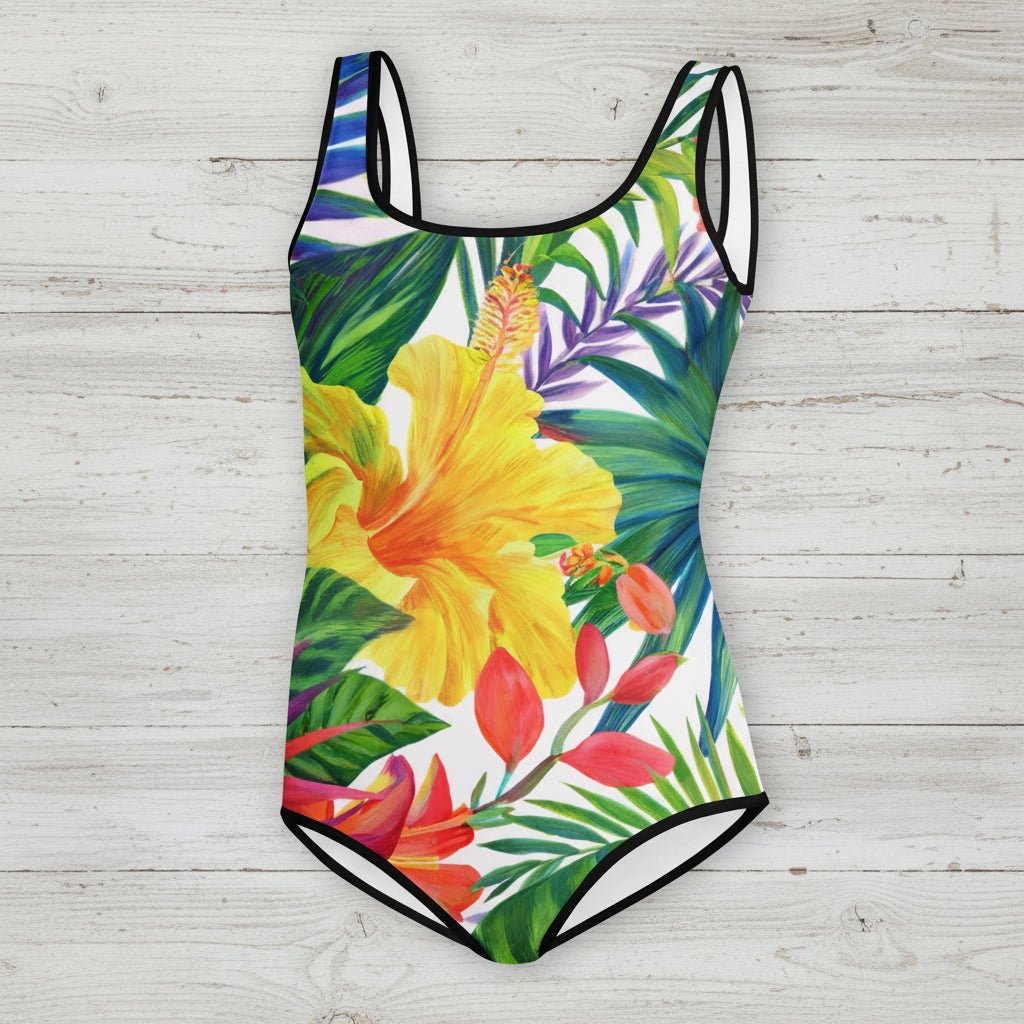 One-piece swimsuit with tropical floral design on a rustic wood background