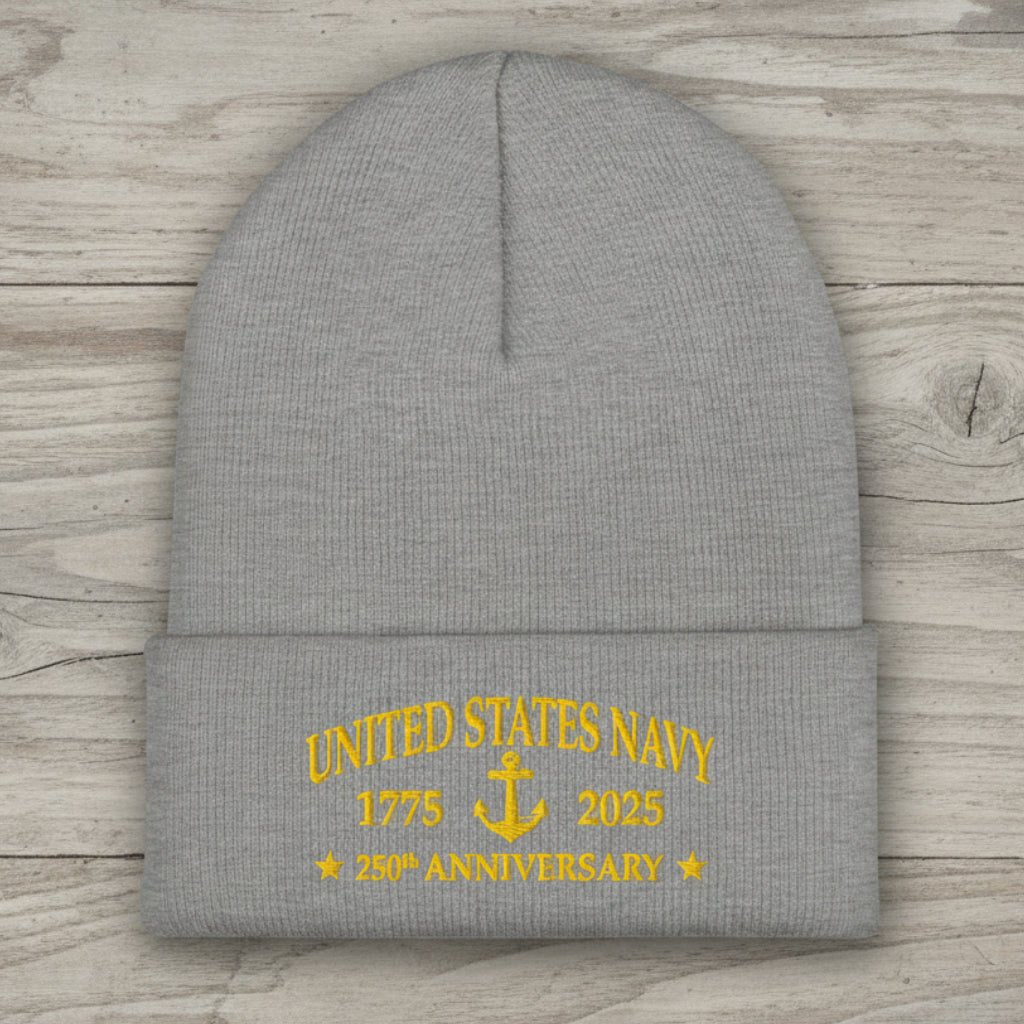 A heather gray knit beanie with a folded cuff featuring yellow embroidered text that reads 'UNITED STATES NAVY 1775 2025 250th ANNIVERSARY' with an anchor graphic.
