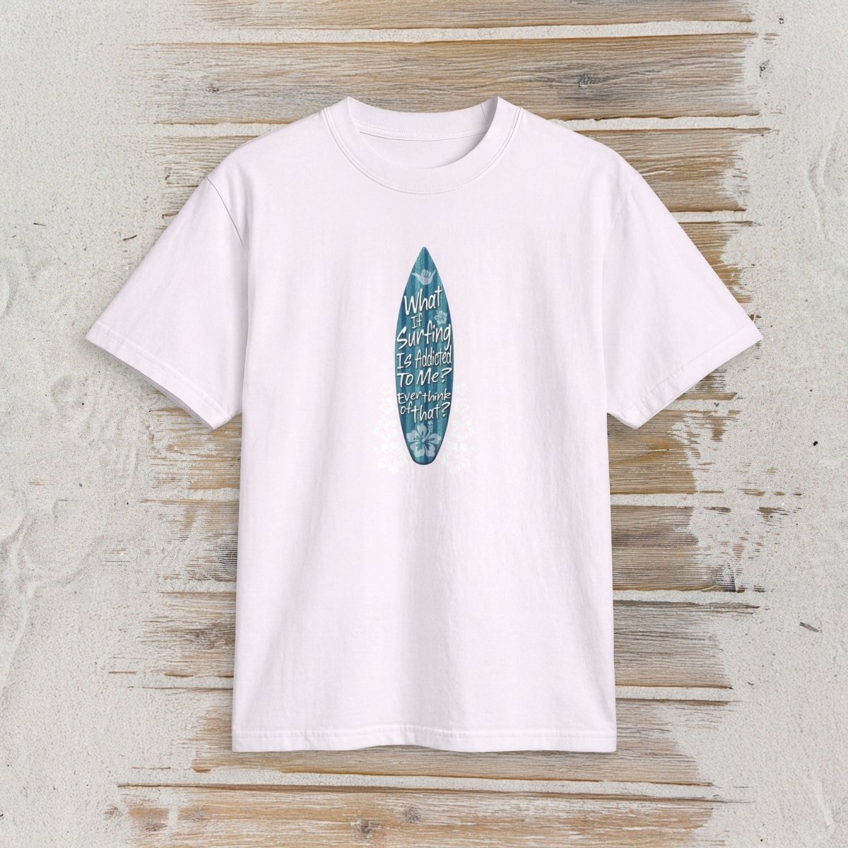 A white short-sleeve crewneck t-shirt featuring a vertical blue surfboard graphic with the text 'My World Is Surfing To Me' on a rustic, whitewashed wooden background.