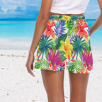 women wearing a colorful tropical patterned skirt on a beach.