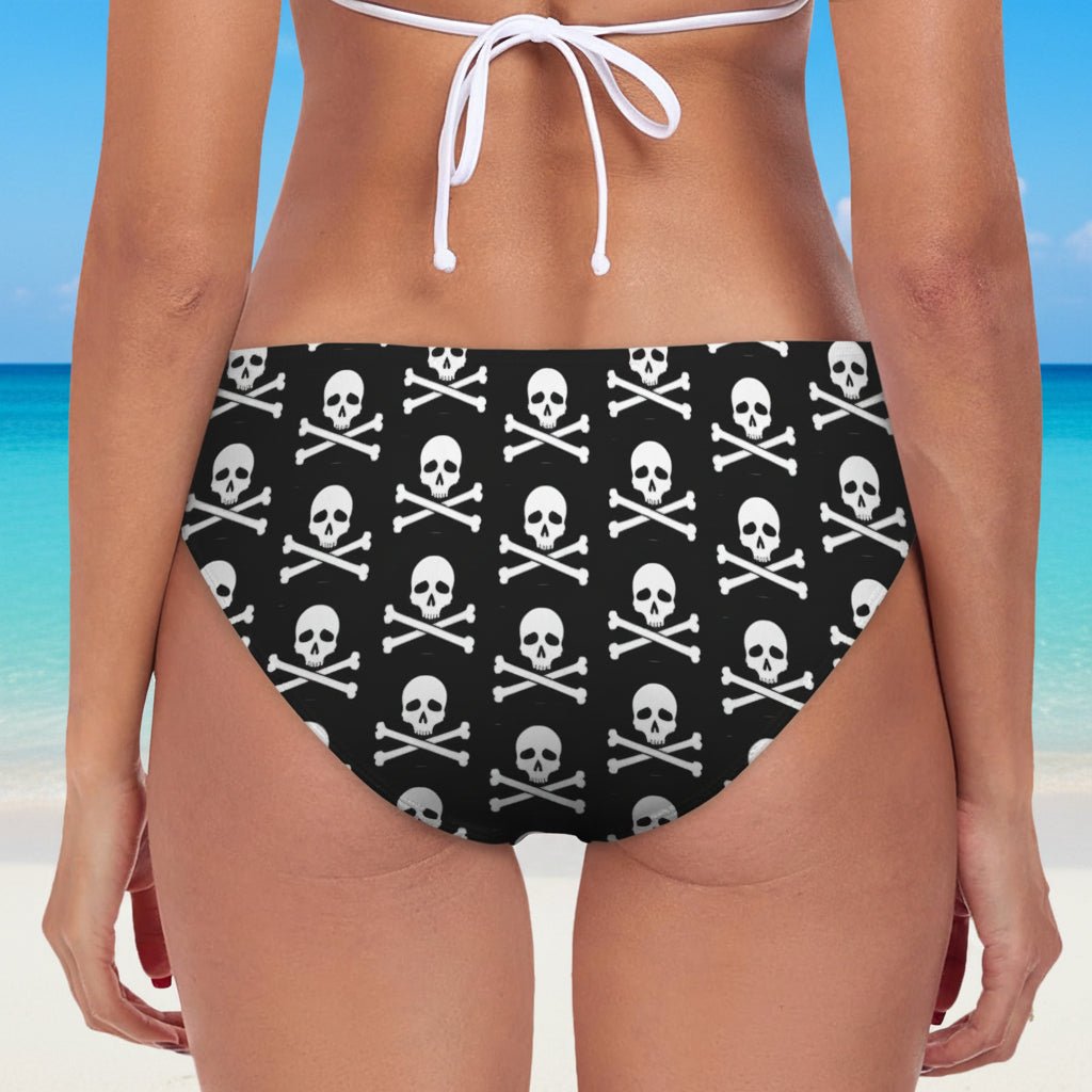 Black bikini bottom with skull and crossbones pattern on a white background