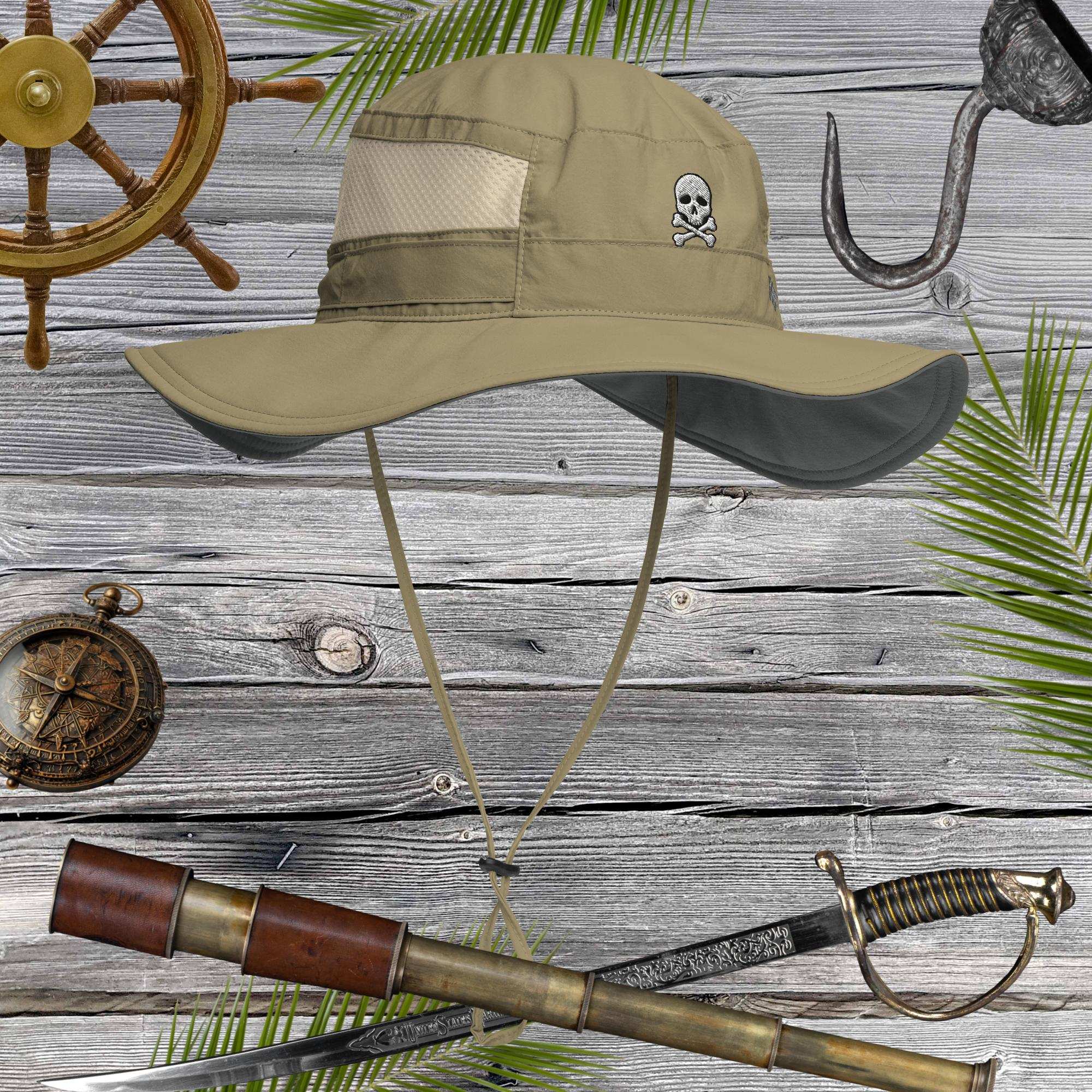 Beige bucket hat with embroidered jolly roger pirate skull emblem on a wooden background with nautical items.