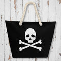 Black bag with a skull and crossbones design and rope handles on a rustic wood background