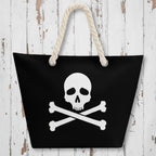 Black bag with a skull and crossbones design and rope handles on a rustic wood background