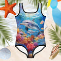 little girls Dolphin Swimsuit with beautiful image of mother and baby dolphins swimming over a coral reef. hovering over the water's edge and beachy backdrop