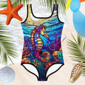 Beautiful sea horse in stained glass style print on a cute one piece swimsuit for girls on a beachy background.