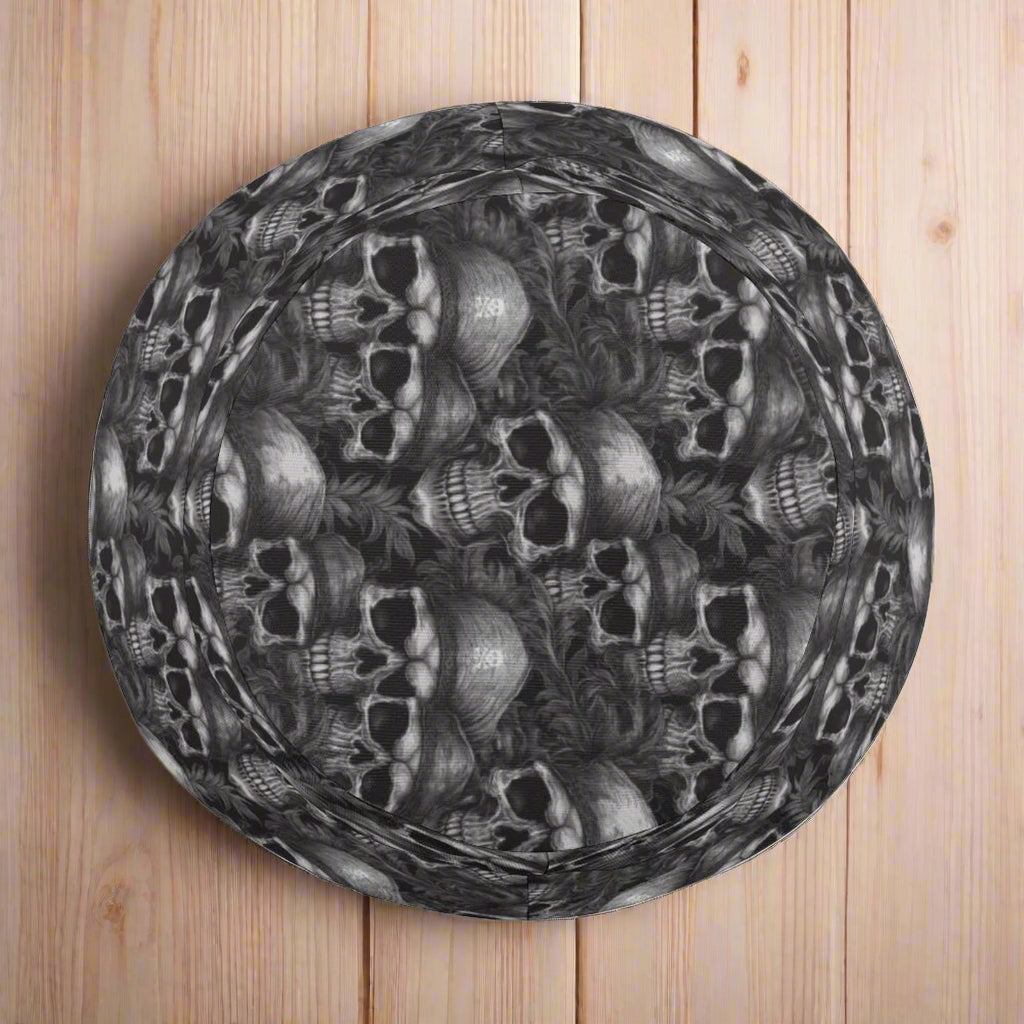 Kids' black bucket hat with skull and crossbone patterns on a nautical wood background
