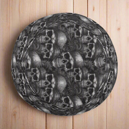 Kids' black bucket hat with skull and crossbone patterns on a nautical wood background
