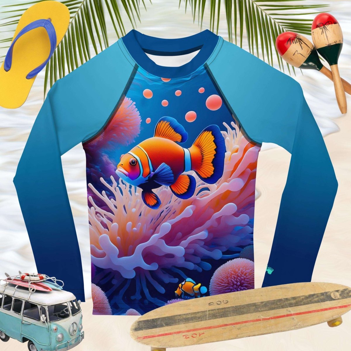 Children's blue rashie with fish design on a beach setting with flip-flops, surfboard, and a toy van.