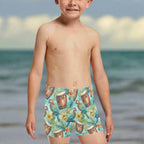 Child wearing colorful tropical-themed swim shorts on the beach in Key West