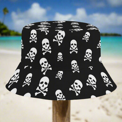 Black bucket hat with white skull and crossbones pattern sitting on a post in a Caribbean island beach