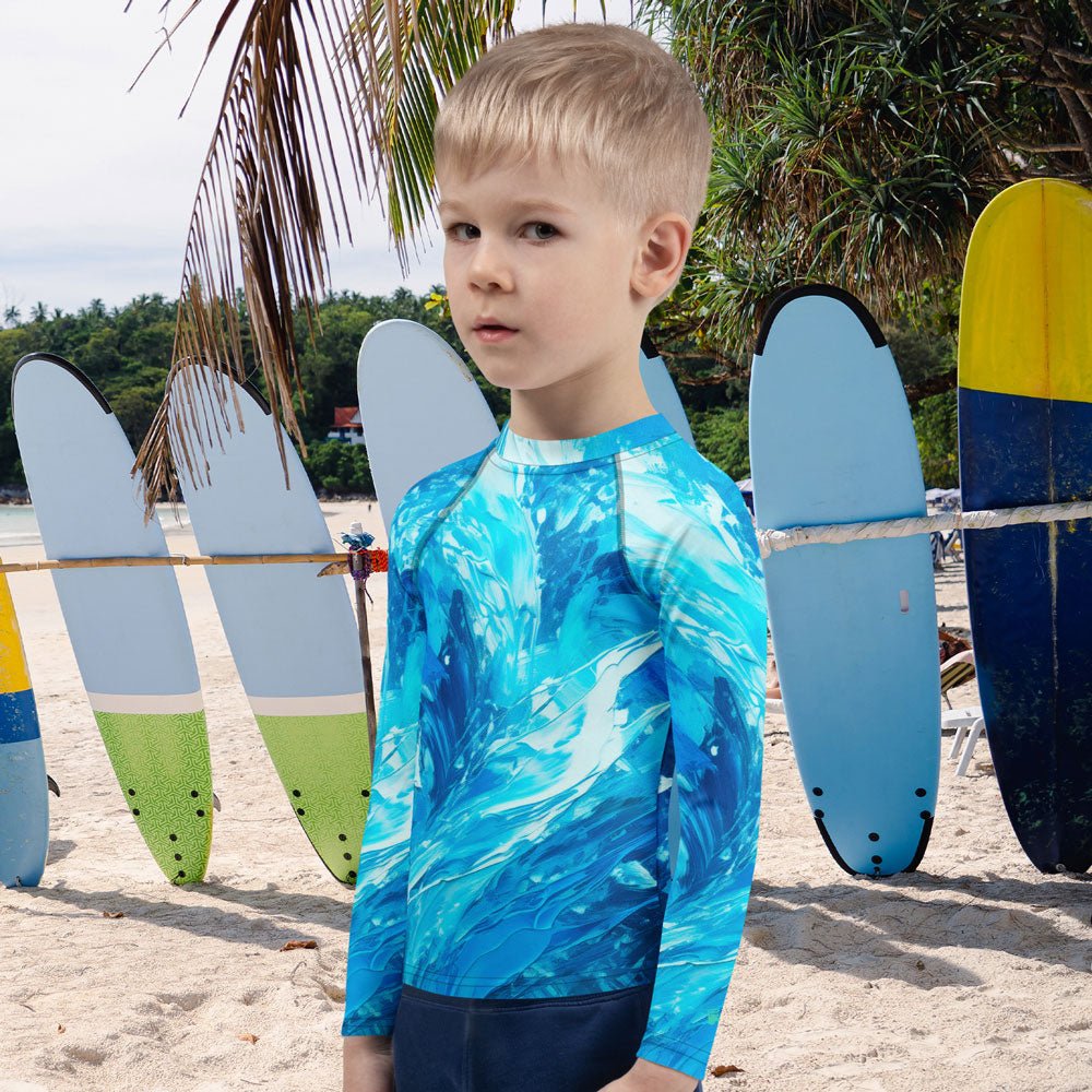 Child wearing a blue rash guard with a surfboard-themed background