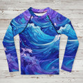 Long-sleeve kids rash guard with blue and purple wave pattern on a rustic wood background