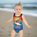 Surfer Girl toddler making her way down the beach in her cool SurferGirl one piece swimsuit