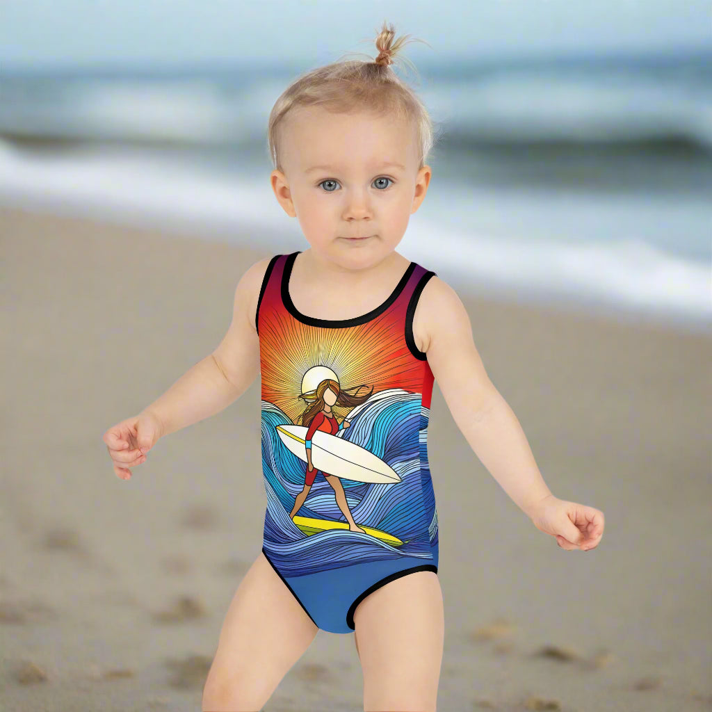 Surfer Girl toddler making her way down the beach in her cool SurferGirl one piece swimsuit