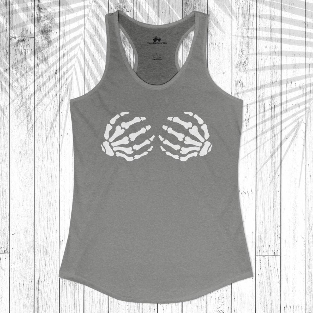 A gray racerback tank top with a white graphic of two skeletal hands on the chest, displayed flat against a white wood plank background with a palm leaf shadow overlay.