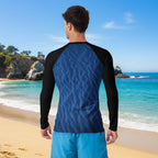 Man wearing a blue and black long-sleeve sun rashie on Laguna beach with ocean view