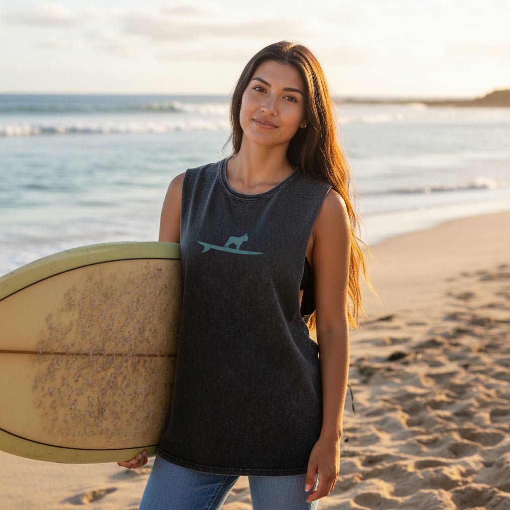 Woman wearing a dark gray sleeveless shirt with a gray surf dog design on laniakea beach in Oahu 