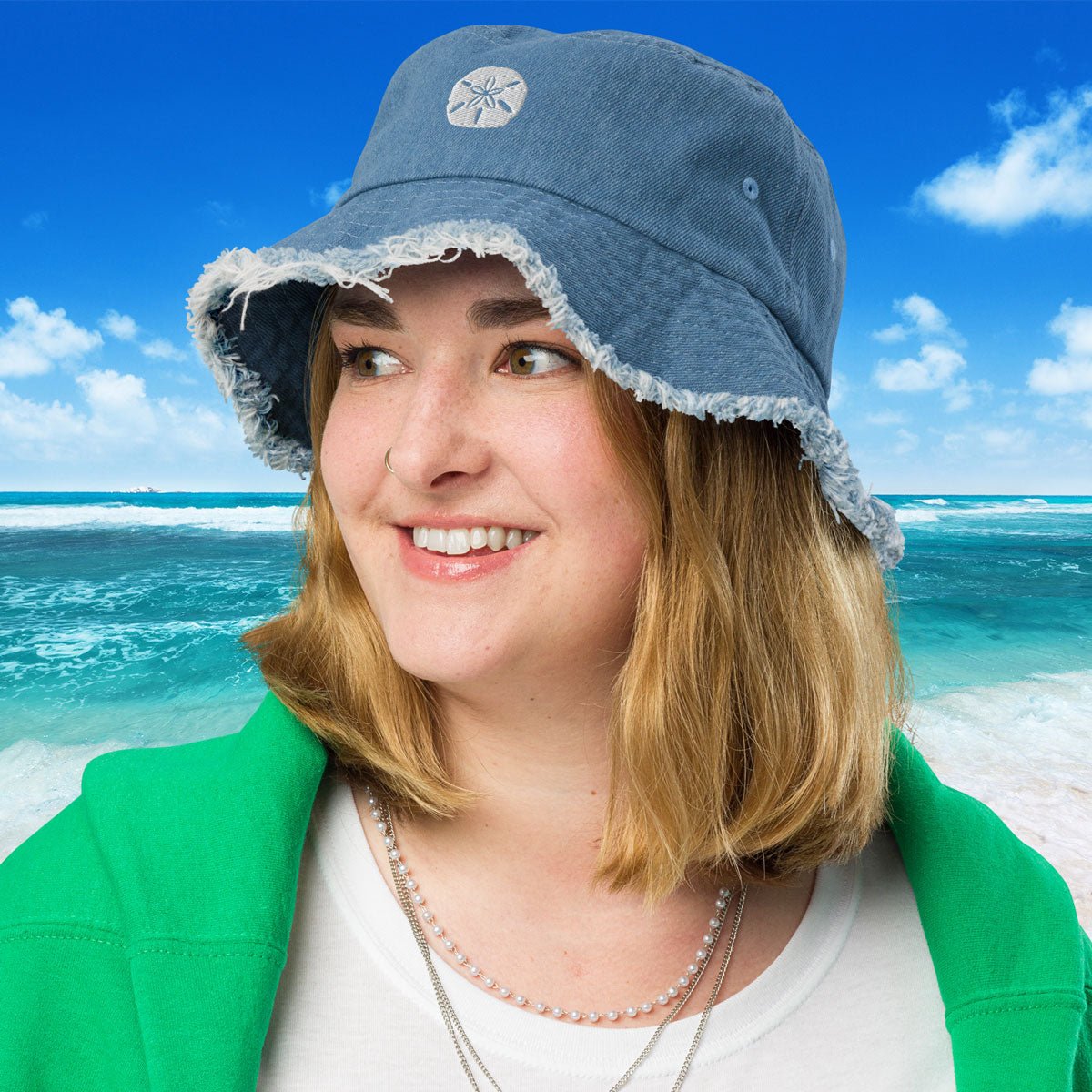 Person wearing a blue denim hat with a beach background