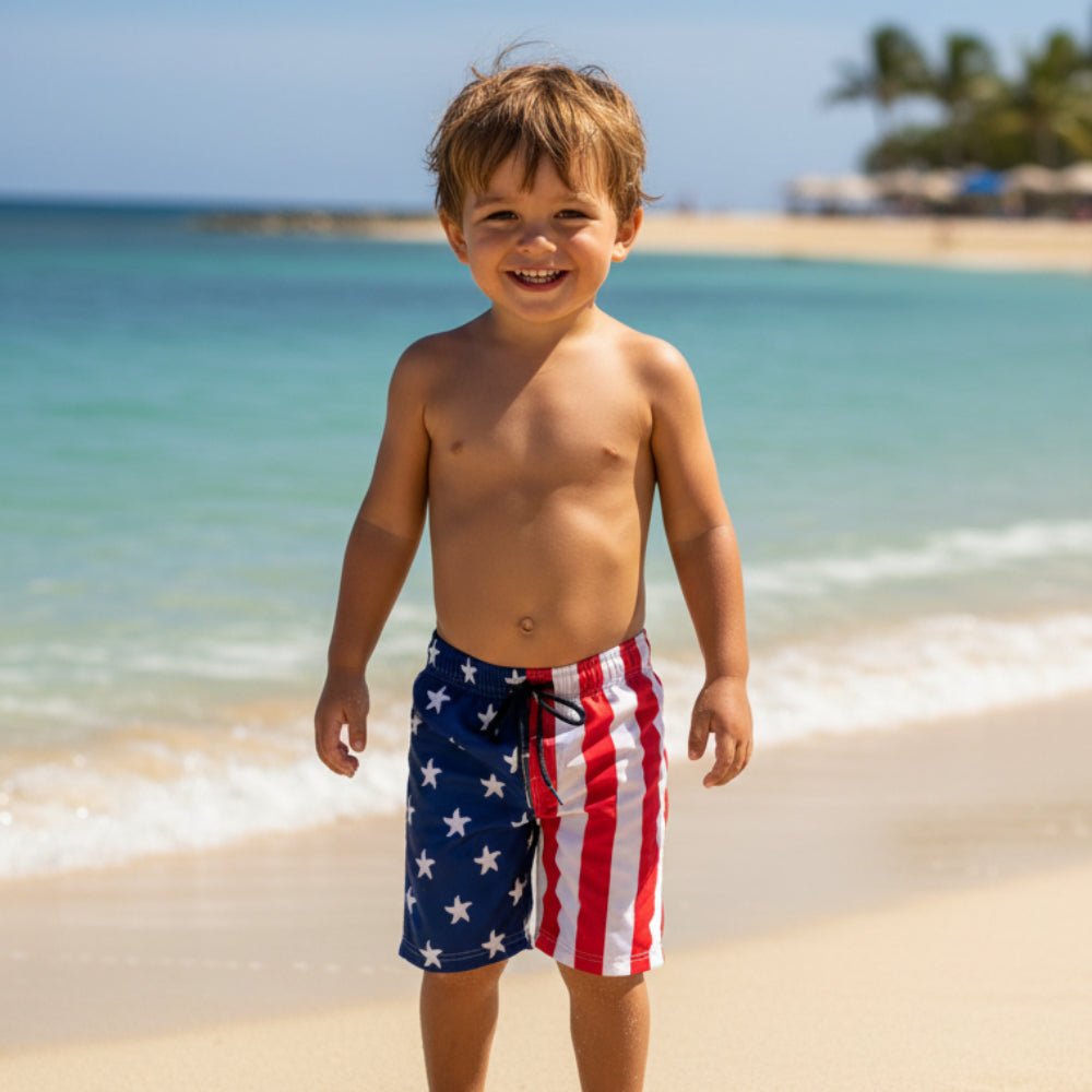 Child wearing American flag USA Flag Beach Shorts on a beach