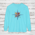 Light blue long-sleeve shirt with a colorful compass design on a white background
