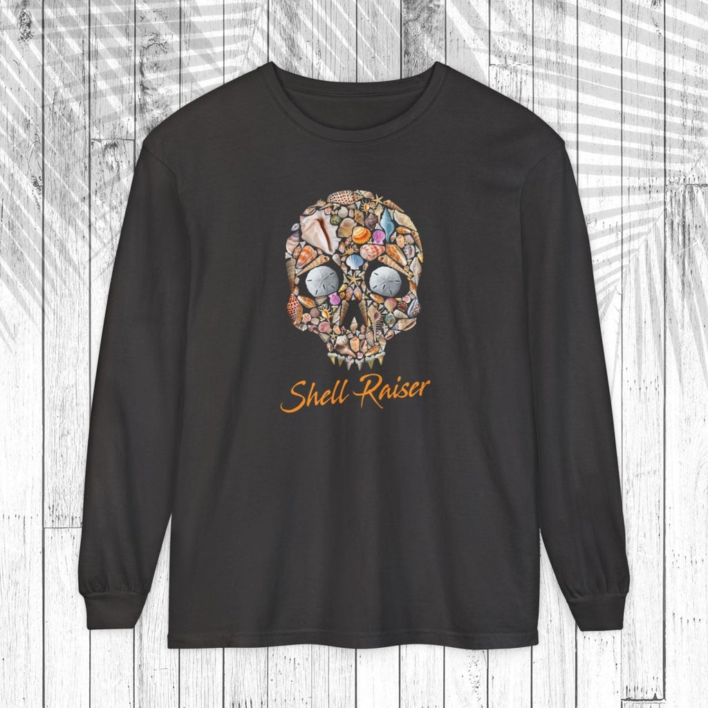A black long-sleeve t-shirt with a colorful skull graphic made of various small objects and the text 'Shell-Raiser' in orange cursive, displayed on a white wood plank background.