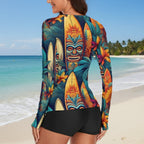 Colorful long-sleeve top with tiki mask and surfboard design on a white background